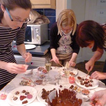 Three ladies making chocolates at a chocolate making party