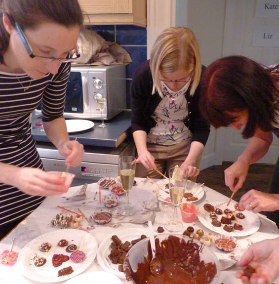 Three ladies making chocolates at a chocolate making party